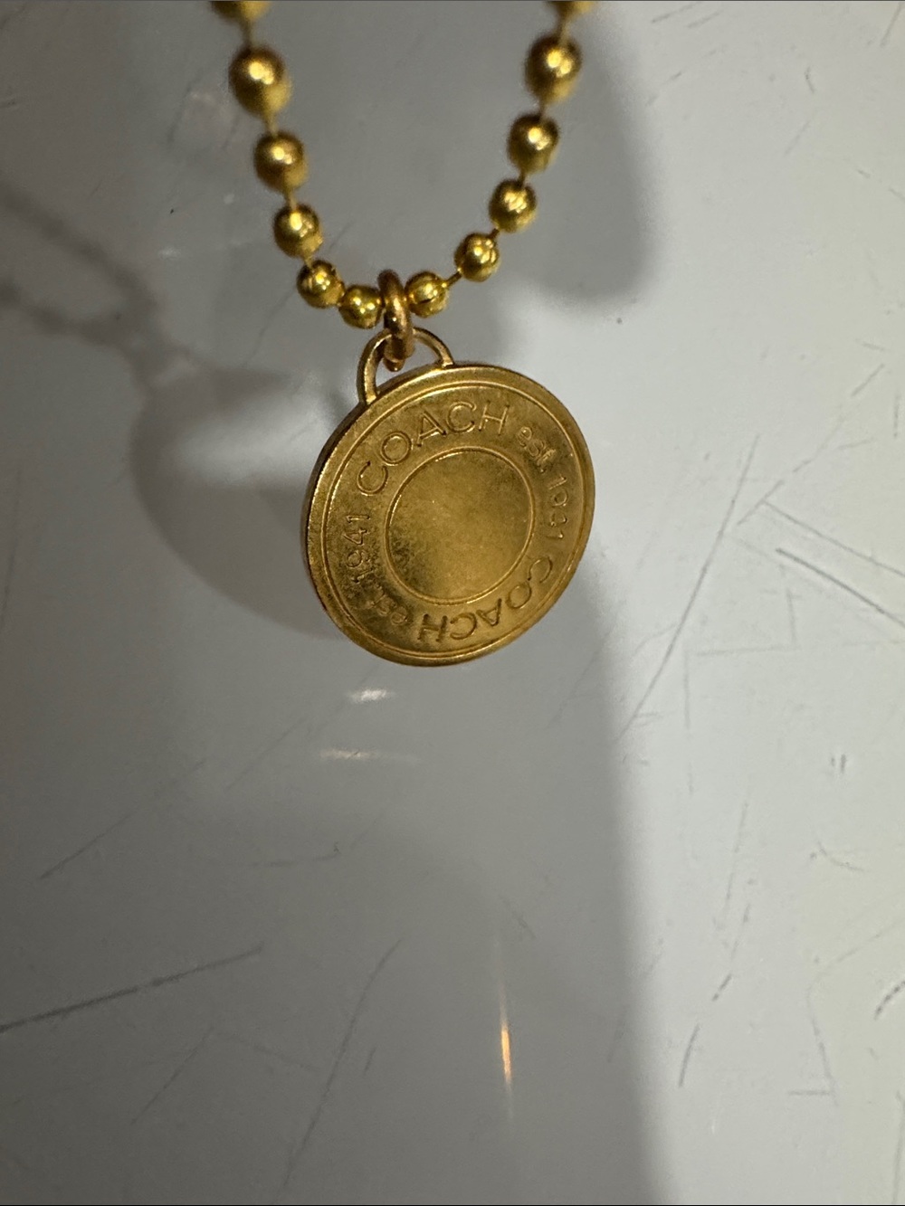 Coach Gold-Tone Round Logo Pendant Necklace